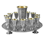 Ornate silver goblet set on tray