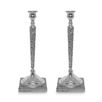 Two silver candle holders on white background